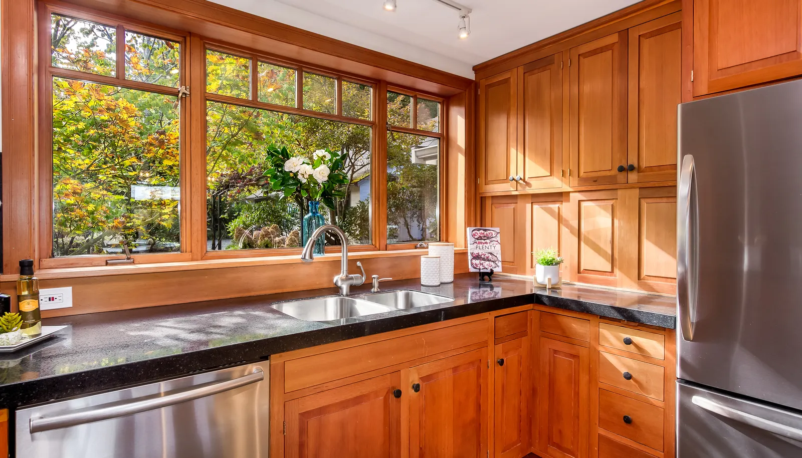 Quality quartz counters, custom cherry cabinetry, Vertical Grain Fir Windows (throughout the entire home) and view to the garden