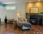 enjoy the custom fireplace while sitting in the spacious living room