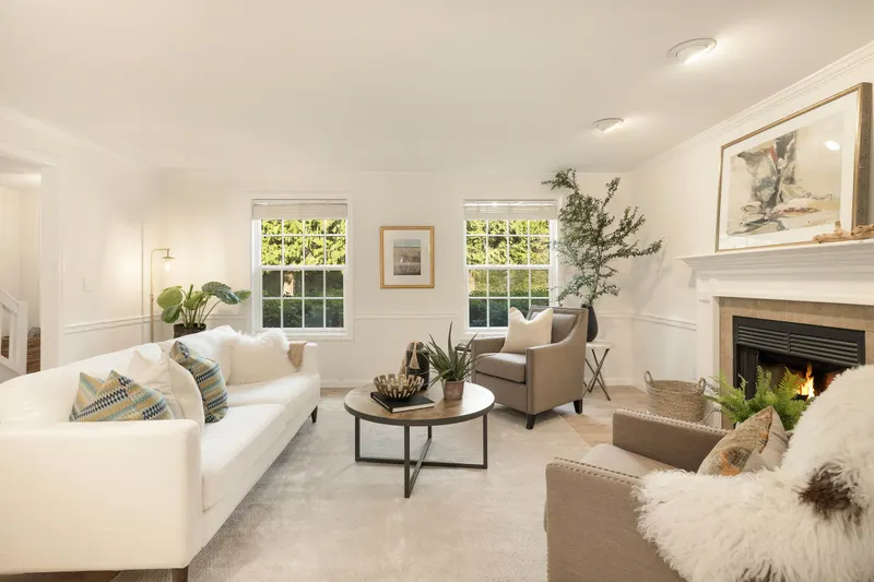 Tall windows offer views to the front lawn and gardens. Wood burning fireplace with custom surround and mantle. Tall ceilings.