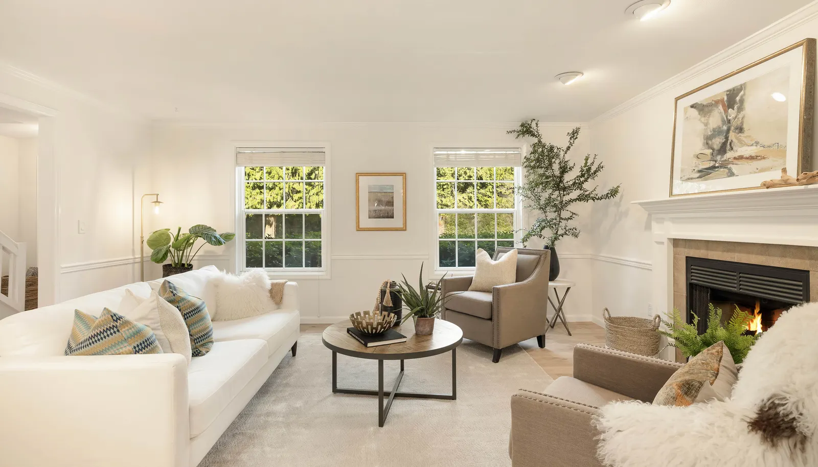 Tall windows offer views to the front lawn and gardens. Wood burning fireplace with custom surround and mantle. Tall ceilings.