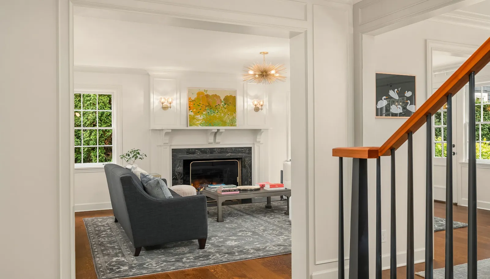 A wood burning fireplace anchors the perfectly proportioned living room.