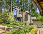 Looking from the entry over the gardens toward the southwest with the three car garage and studio above 