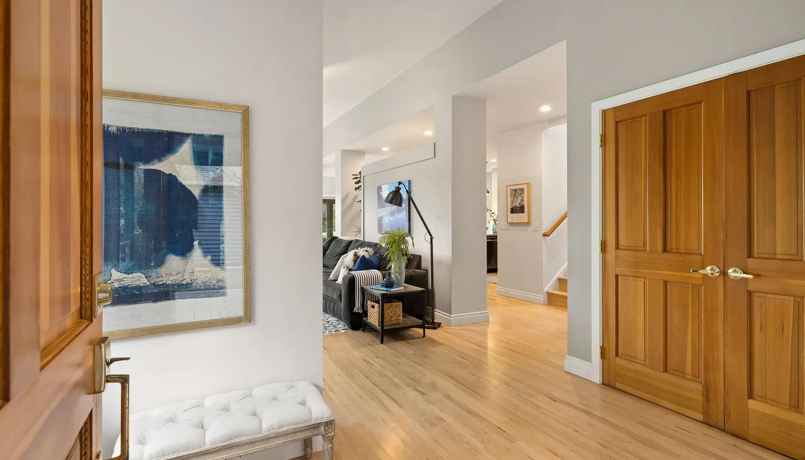 Spacious front entry showcases the beautiful maple floors and open floor plan