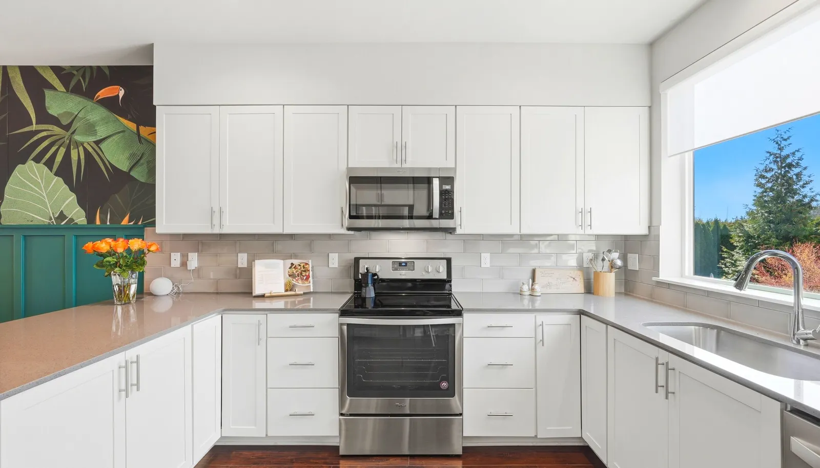 The functional kitchen features crisp white cabinetry, clean lines and efficient layout.