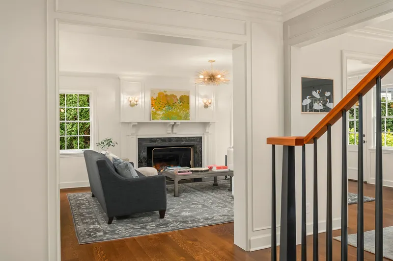 A wood burning fireplace anchors the perfectly proportioned living room.