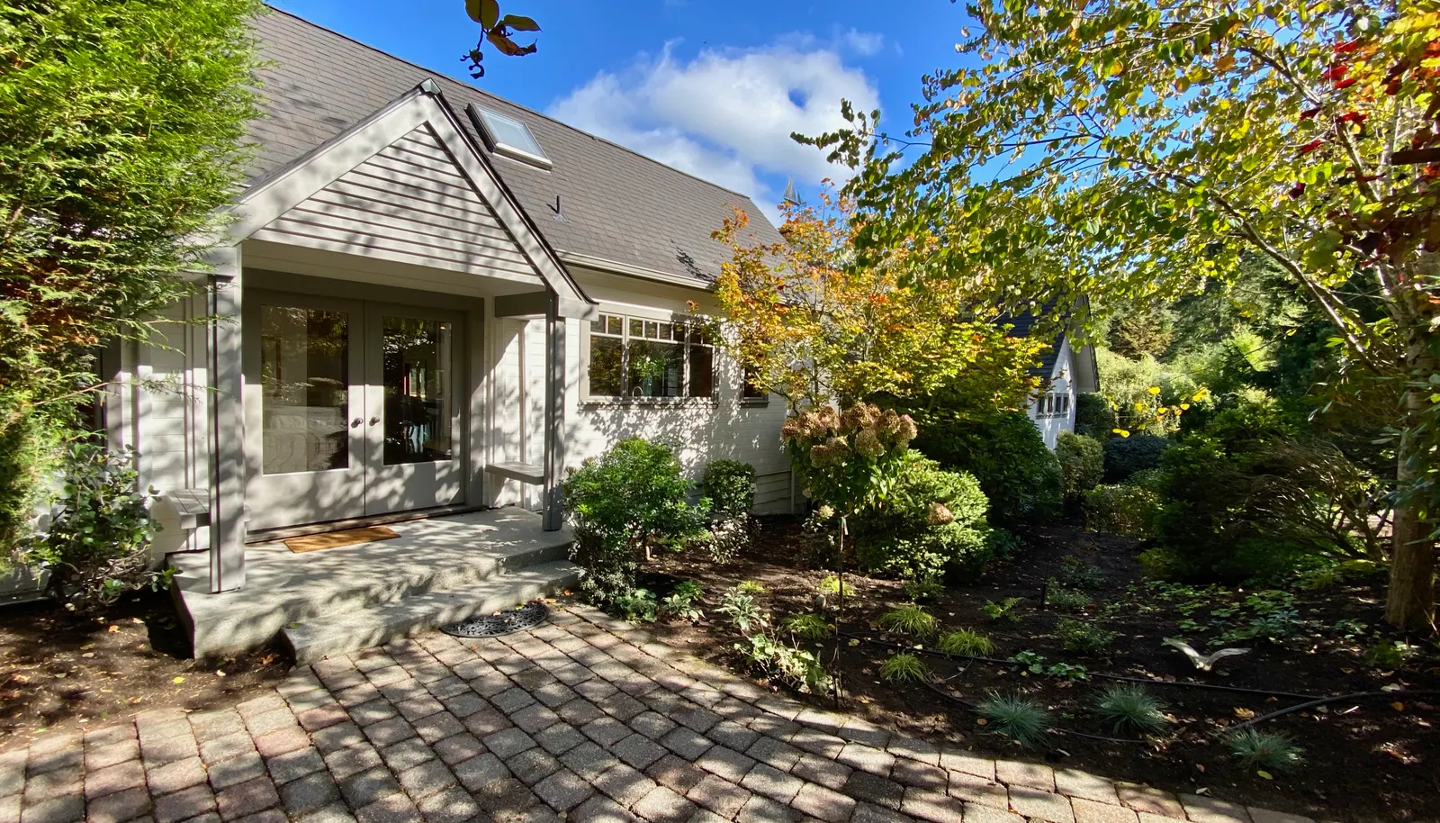 Paleo stones lead through the gardens to the original entrance of the home. New roof and all new exterior paint!