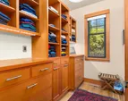 The primary closet with custom built-ins and more space to the right. And who doesn't love a closet with a window! 
