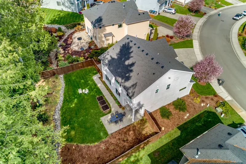 HUGE, private, fully fenced backyard with lush lawn, planter boxes, and your own little forest!