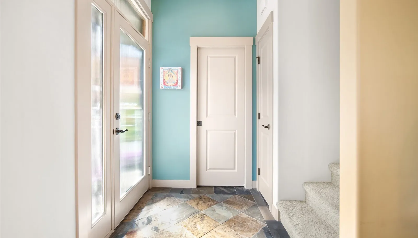 Welcoming entry with natural light and a direct connection into the home.