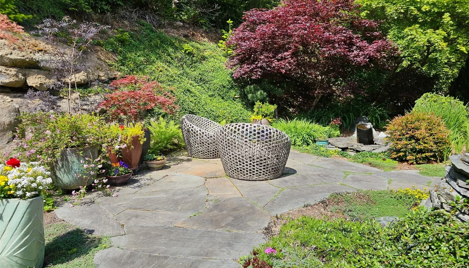 lots of beautiful mature trees and plants in this custom landscape