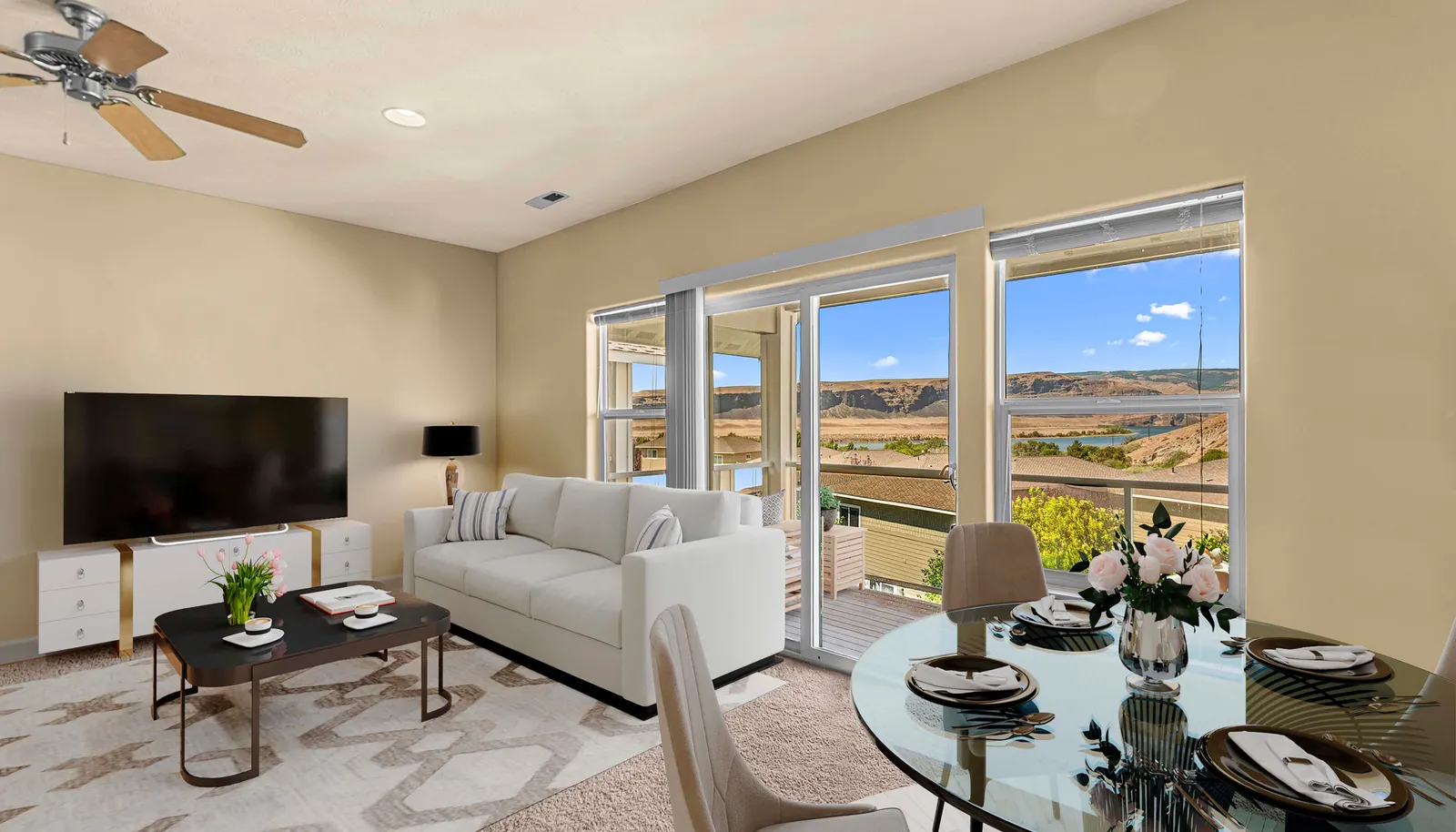 Spacious living room with natural light, picture windows, and open flow to dining and kitchen