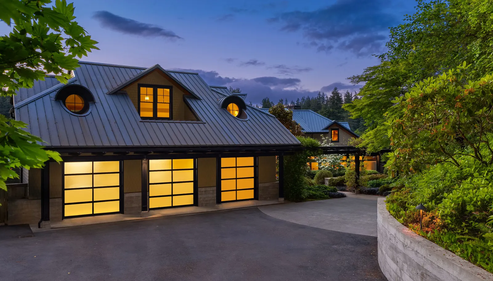 The three car garage includes extra storage, separate entry to the studio and doors that open to the upper gardens. 