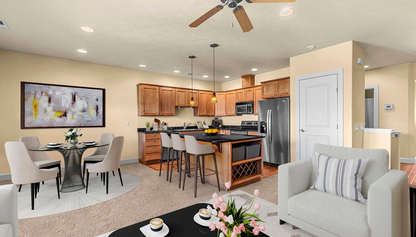 Inviting living area with ceiling fan, modern finishes, and versitile layout