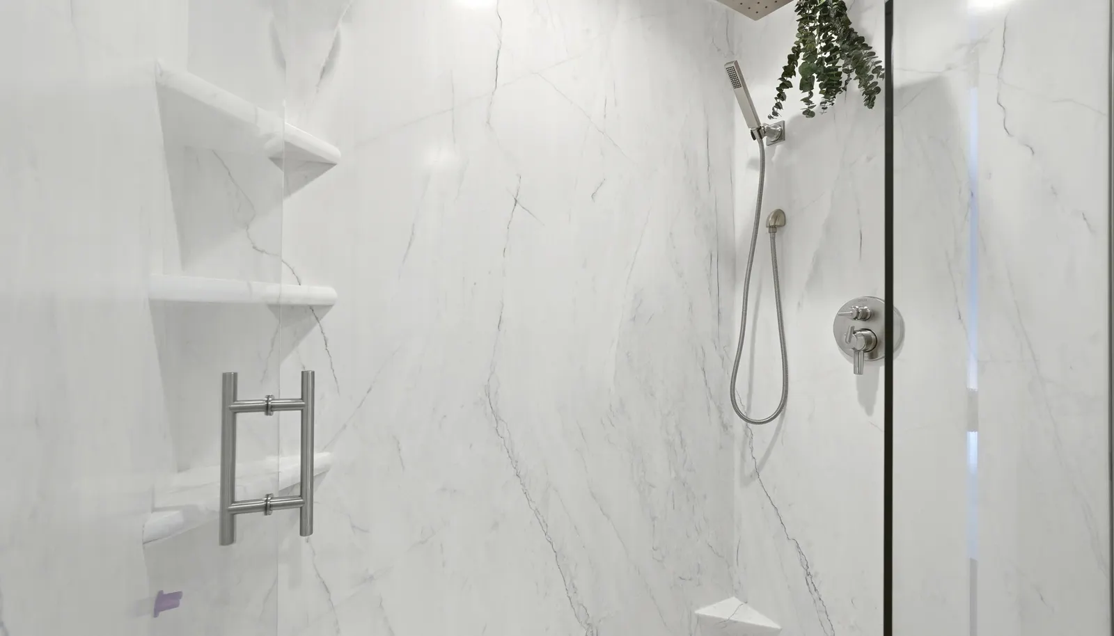 The shower has been recently remodeled with a low-maintenance, grout-free floor and surround for effortless upkeep.