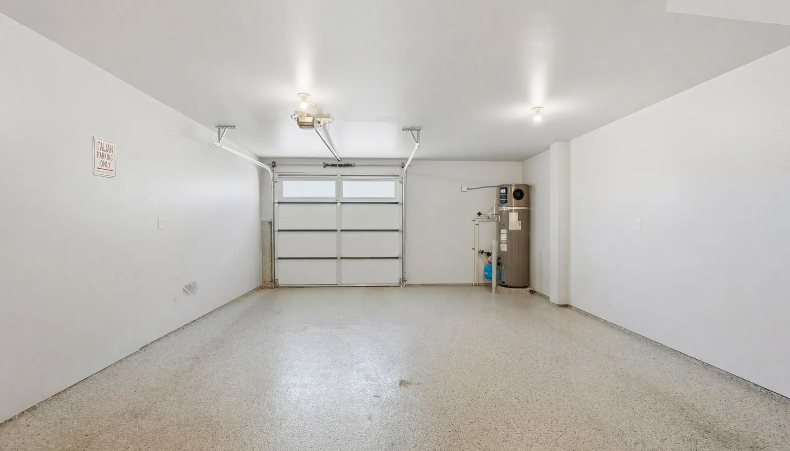 Extra-deep 2-car tandem garage upgraded with epoxy flooring, insulation and finished walls.