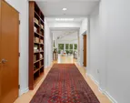A dramatic entry sets the tone, flanked by custom built-in bookcases complimented by an oversized coat closet.
