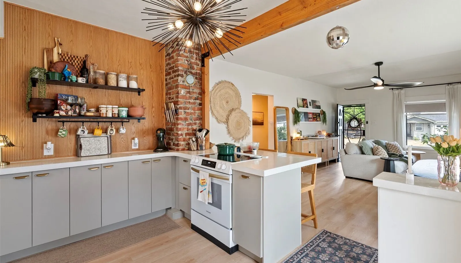 The kitchen has been extensively refreshed with new cabinetry, appliances, and distinctive concrete countertops